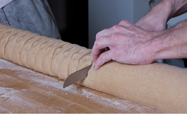 Cutting the cinnamon rolls at True Grain Bread