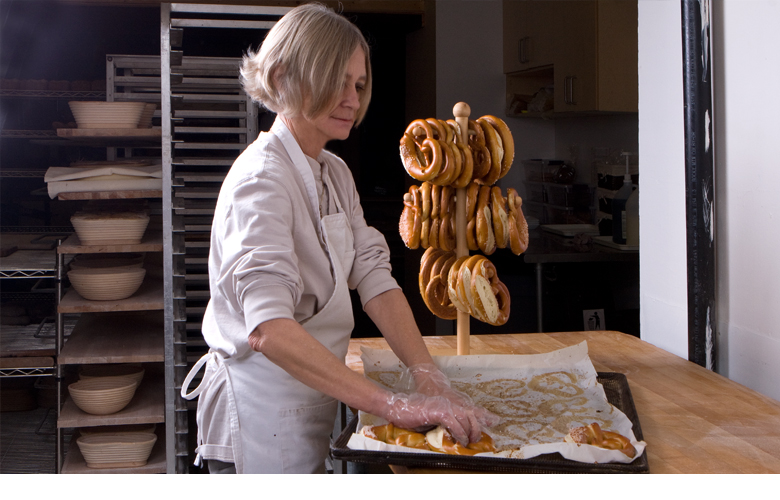 Marlene putting the freshly baked pretzls on the pretzl stand