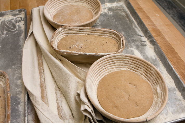 Bread dough resting in clay pots at True Grain Bread